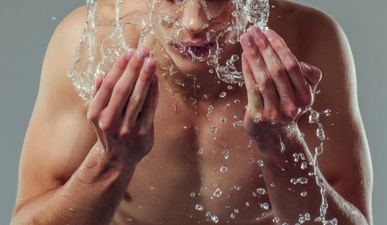 Man splashing face with water